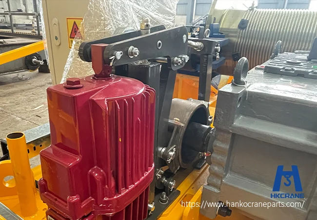 Crane brake system maintenance, technician inspecting industrial crane electromagnetic brake