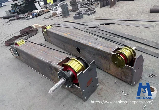 Heavy-duty crane wheel operating in steel plant high temperature environment with visible rail and wheel tread