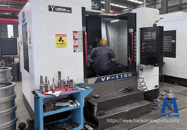 CNC vertical lathe machining a forged crane wheel blank to final tread diameter