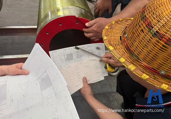 Worker measuring crane sheave groove wear with a gauge during quality inspection