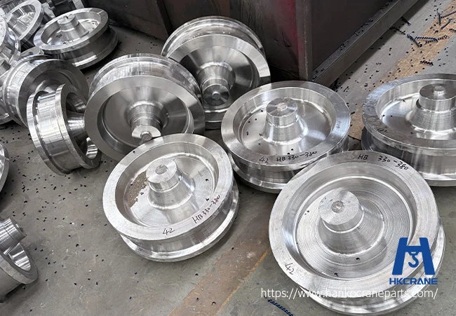 Forged crane wheels with machined tread surface and double flange, finished and ready for export