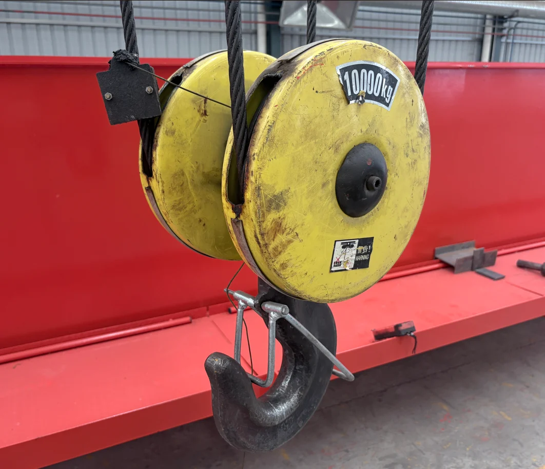 Forged single crane hook with nameplate showing rated load and serial number