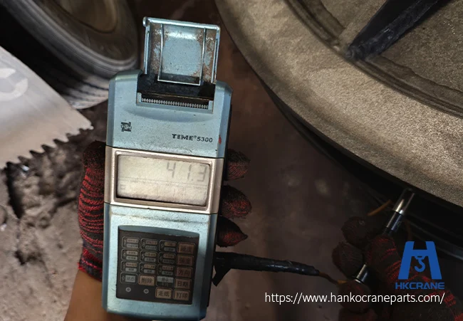 Inspector checking a custom crane sheave groove with an electronic measuring instrument