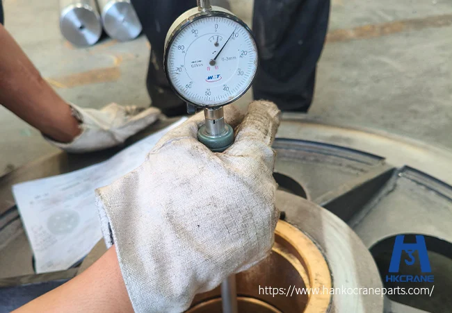 Inspector measuring a crane sheave bushing bore with a dial bore gauge